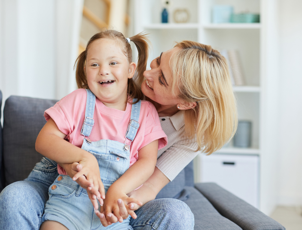 A child with a disability with a carer from concept care smiling