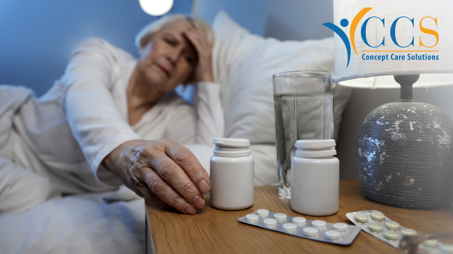 Older woman struggling in the evening with medication beside her bed