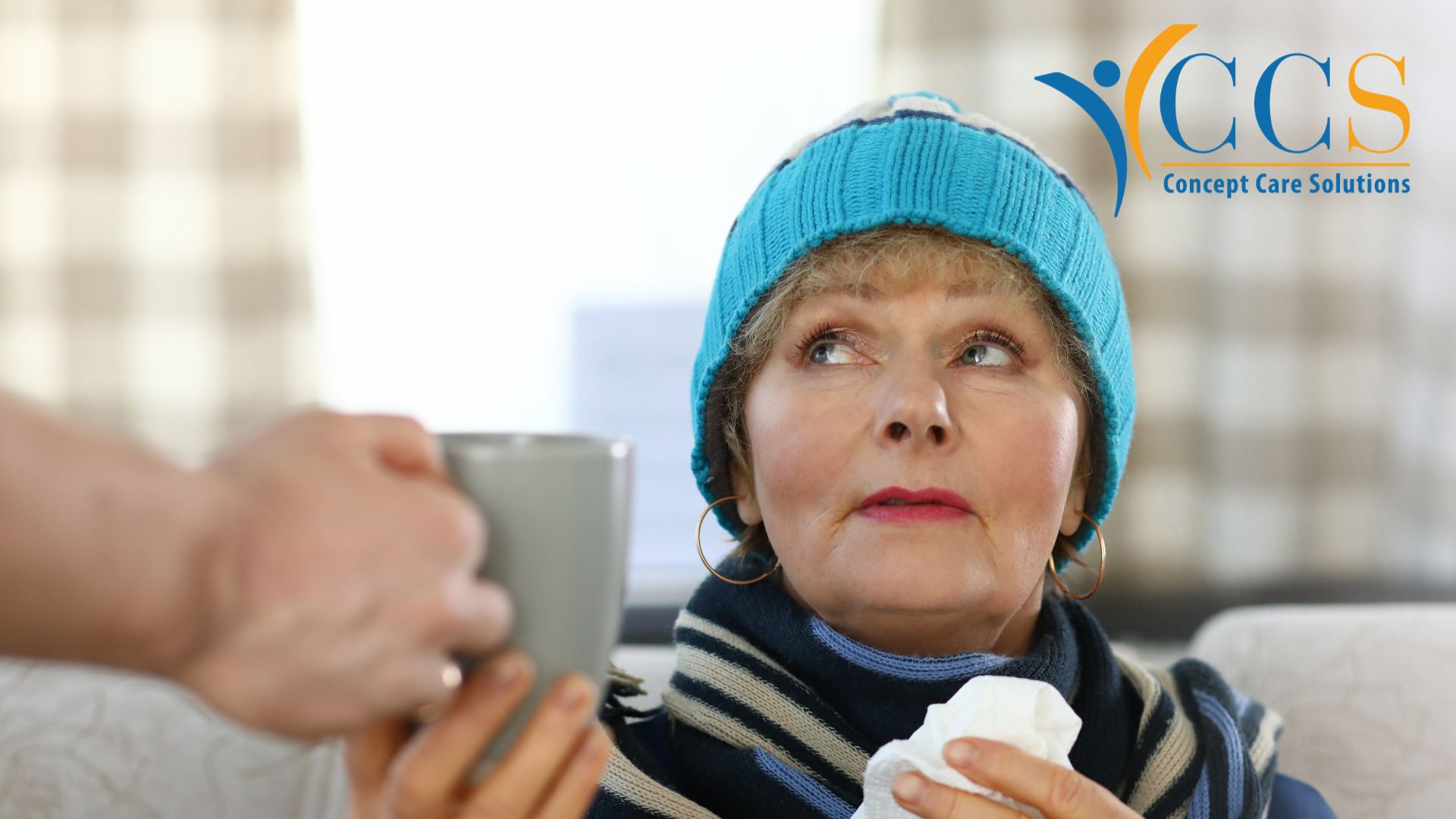 Older woman keeping warm during colder weather with a hot drink